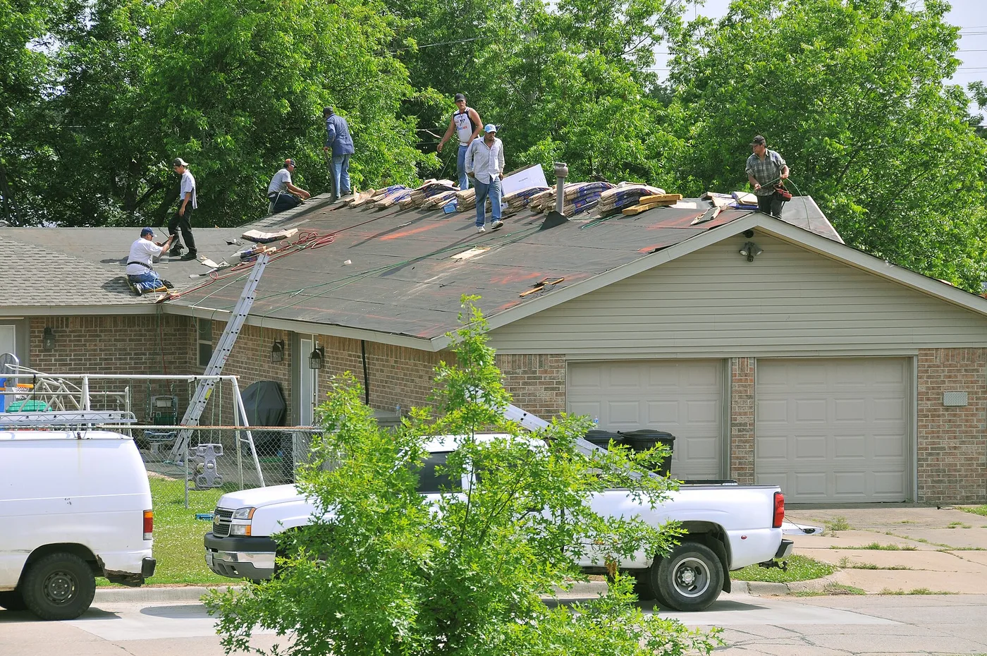 Roofers working together on a residential roof repair
