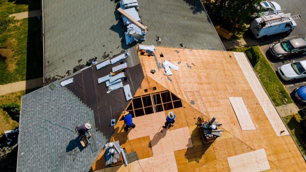 Roofers working on a roof, aerial view.